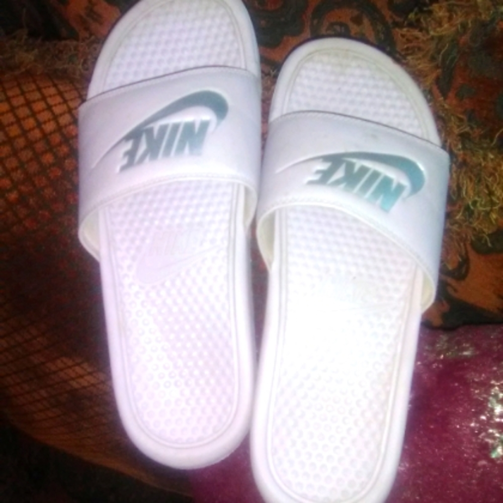 Women's pink and and silver Nike slides